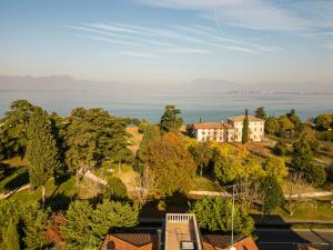 an aerial view of a house on a hill next to the water at [Lago di Garda a 50 metri] La casa di Pamela in Desenzano del Garda +5 photos
