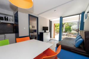 a bedroom with a bed and a table and chairs at Residence Vacances Bleues Lou Castel in Casteljau