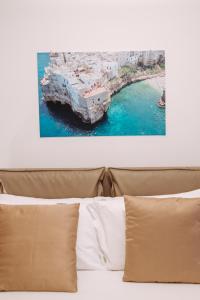 a bed with a view of a boat in the water at Piccinni Exclusive Suite in Bari
