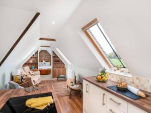 an attic kitchen and living room with white walls at Pass the Keys Tranquil Chilterns Farm Hideaway in Little Missenden