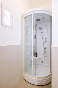 a shower with a glass door in a bathroom at Piccinni Exclusive Suite in Bari