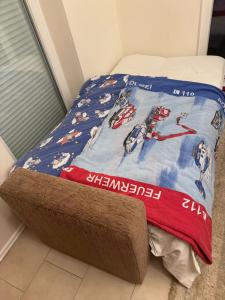 a bed in a room with a hockey blanket on it at Sunnyside Hasloh 