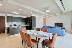 a dining room and kitchen with a table and chairs at D'Rapport Residence KL by manatidur in Kuala Lumpur