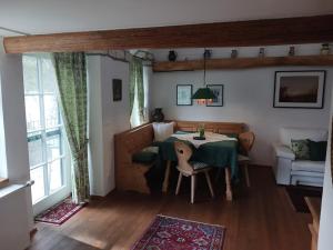 a dining room with a table and a couch at Gästehaus Hans Moser in Purbach am Neusiedlersee