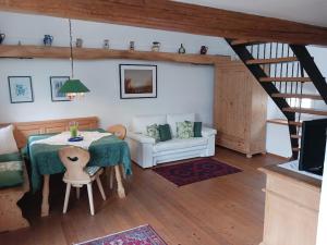 a living room with a table and a couch at Gästehaus Hans Moser in Purbach am Neusiedlersee