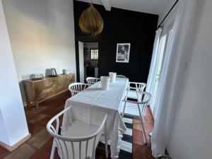 a dining room with a white table and chairs at Le Mas Miliane vous accueille in Sainte-Maxime