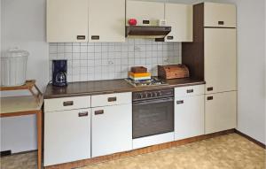 a kitchen with white cabinets and a stove at Awesome Apartment In Kappl With 3 Bedrooms And Internet in Kappl