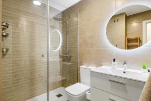 a bathroom with a shower and a toilet and a sink at MEDANO4YOU Arecas Del Mar in El Médano