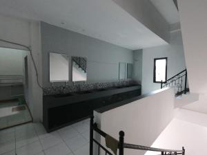 a room with a staircase and a stair case at Innbox Hostel in Sorong