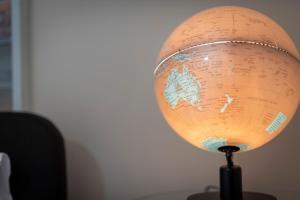 a globe on top of a wooden table at Hobart City Townhouse in Hobart