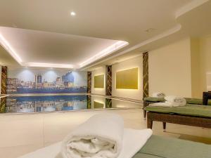 a room with two beds and a balcony with a view at Courtyard by Marriott Hamburg Airport in Hamburg
