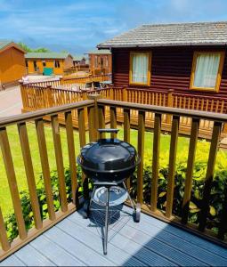 a bbq grill on the deck of a house at 23 Ocean View Lodge TJS 23875 in Ilfracombe