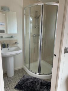 a bathroom with a shower and a sink at 23 Ocean View Lodge TJS 23875 in Ilfracombe