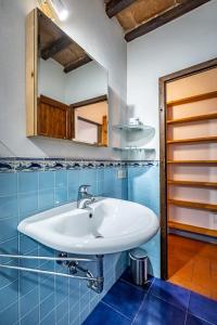 a bathroom with a sink and a mirror at Roommo Oltrarno in Florence