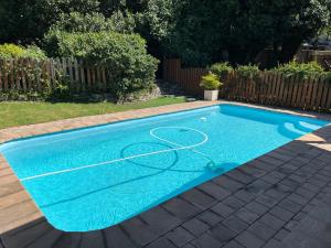 a swimming pool with a basketball hoop in a yard at The Garden on Phantom - "Off the grid" in Knysna