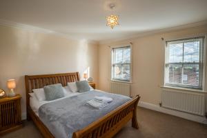 a bedroom with a bed and two windows at Spacious, 3 Bed House for 6 in Central Chester in Chester