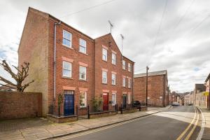 an empty street with a red brick building at Spacious, 3 Bed House for 6 in Central Chester in Chester