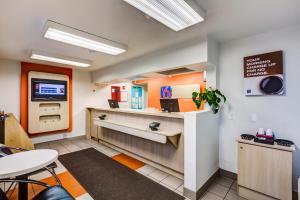 a waiting room with a cash register and a table at Motel 6-Wheat Ridge, CO - West - Denver North in Wheat Ridge