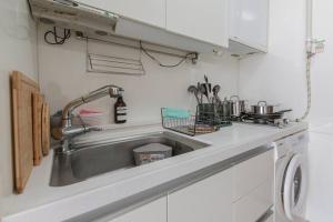 a kitchen with a sink and a stove at MIRAE_stay 52 New Open [1 Queen + 2 Single beds] in Seoul