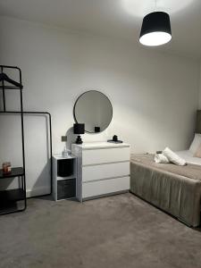 a bedroom with a bed with a mirror and a dresser at Beautiful 1-Bed Apartment in Birmingham - Solihull in Birmingham