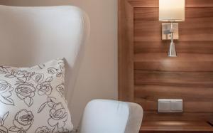 Zimmer mit einem Stuhl, einem Kissen und einer Lampe in der Unterkunft Seehotel Restaurant Lackner in Mondsee