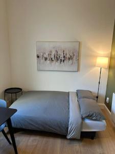 a bedroom with a bed and a painting on the wall at Central Dublin Apartment in Dublin