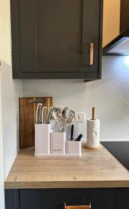 a kitchen counter with utensils on top of it at Central Dublin Apartment in Dublin