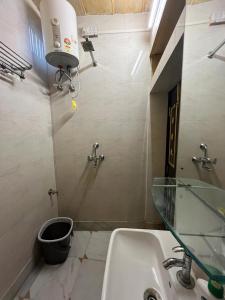 a bathroom with a sink and a glass counter at Hostel Desert Home Stay in Jaisalmer