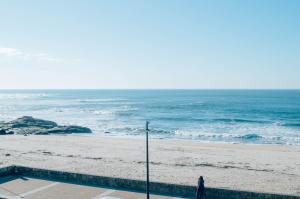 a person walking on the beach near the ocean at Moledo Shoreline in Moledo