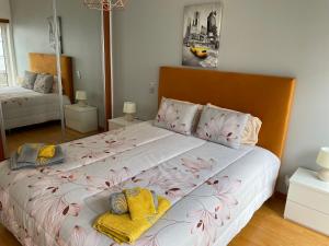 a bedroom with a large bed with two pillows on it at Peixinho Magnifique Appartement in Marinha Grande