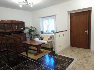 a living room with a table and a couch at villa gesualda in Bagno di Romagna