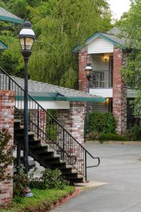 a house with a staircase in front of a house at Grass Valley Courtyard Suites in Grass Valley