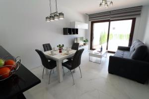 a living room with a table and chairs and a couch at Casa del sur in San Juan de los Terreros