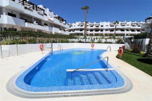 a swimming pool in the middle of a building at Casa del sur in San Juan de los Terreros