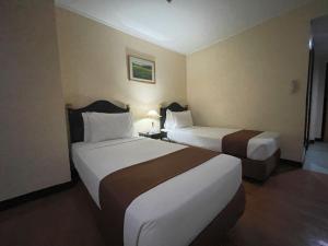 Postel nebo postele na pokoji v ubytování Golden Peak Hotel & Suites powered by Cocotel