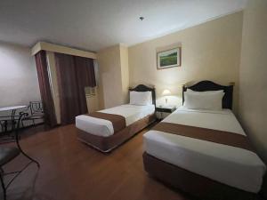 Postel nebo postele na pokoji v ubytování Golden Peak Hotel & Suites powered by Cocotel