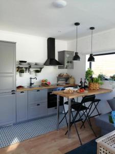 a kitchen with a table and a counter top at Casa Salitre in Boiro
