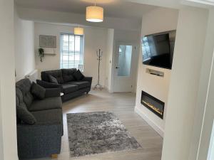 a living room with a couch and a fireplace at Holyhead central stay in Holyhead