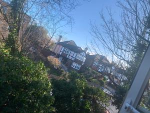 a large house is seen from the street at Beddington Park Lodge West in Wallington