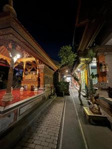 a street at night with a building with lights at Nua House in Ubud