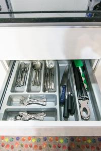 a drawer filled with utensils in a refrigerator at Loft Centro Huelva in Huelva +34 photos