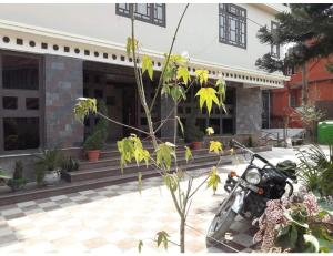 a motorcycle parked in front of a building at Hotel Lasso Regency & Spa, Namchi in Namchi