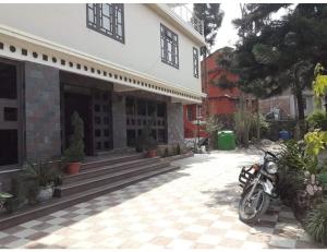 a motorcycle parked in front of a building at Hotel Lasso Regency & Spa, Namchi in Namchi