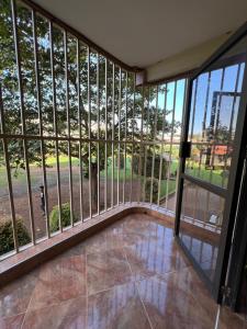 a room with large windows and a view of a park at MD comfort homes in Kampala