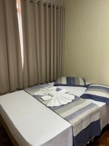 two beds with towels on top of them at Hotel Santa Clara in Caldas Novas