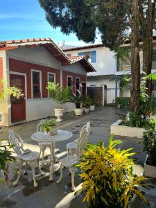 a patio with a table and chairs in front of a house at Hotel Santa Clara in Caldas Novas