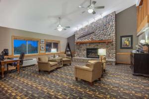 a large living room with a stone fireplace at AmericInn by Wyndham Stillwater in Stillwater