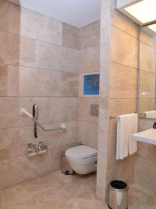 a bathroom with a toilet and a sink at Swissotel Buyuk Efes Izmir in İzmir