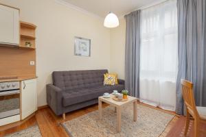 a living room with a couch and a table at Charming Apartment Located near the Promenade in Świnoujście by Renters in Świnoujście