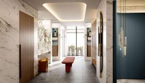a hallway with a red stool and a bathroom at Conrad Bahrain Financial Harbour in Manama